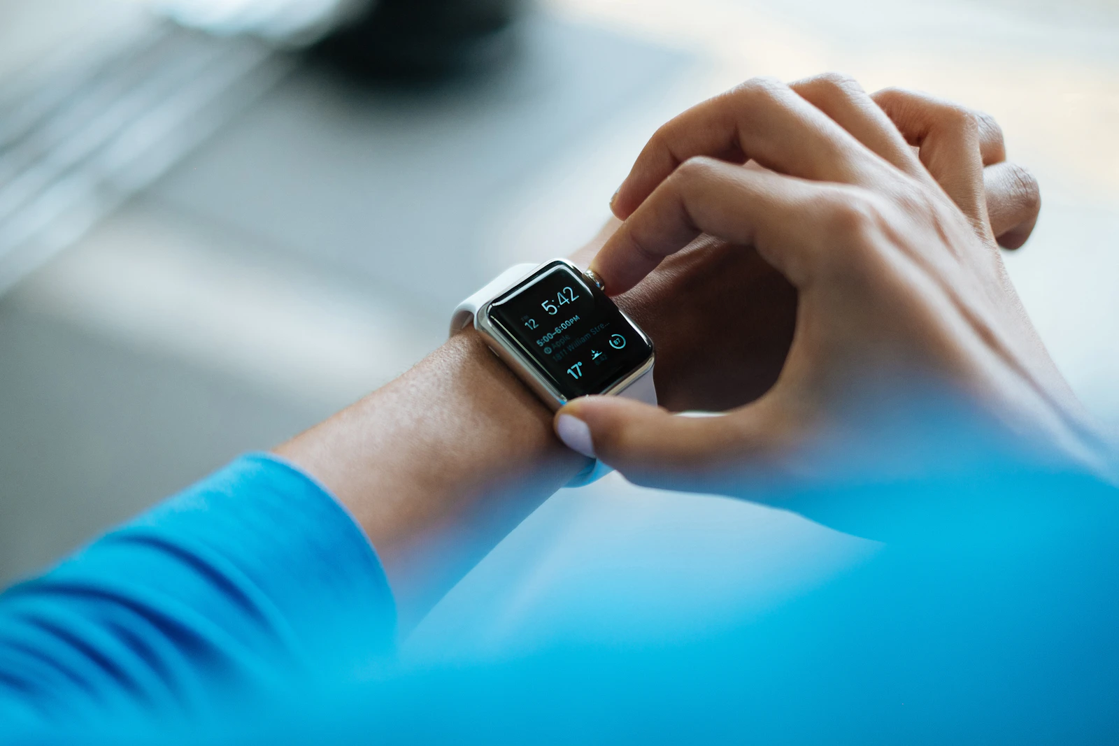 A person checking sleep data on their smartwatch upon waking