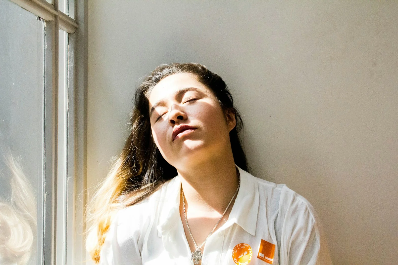 Person taking a break away from the screen near a bright window