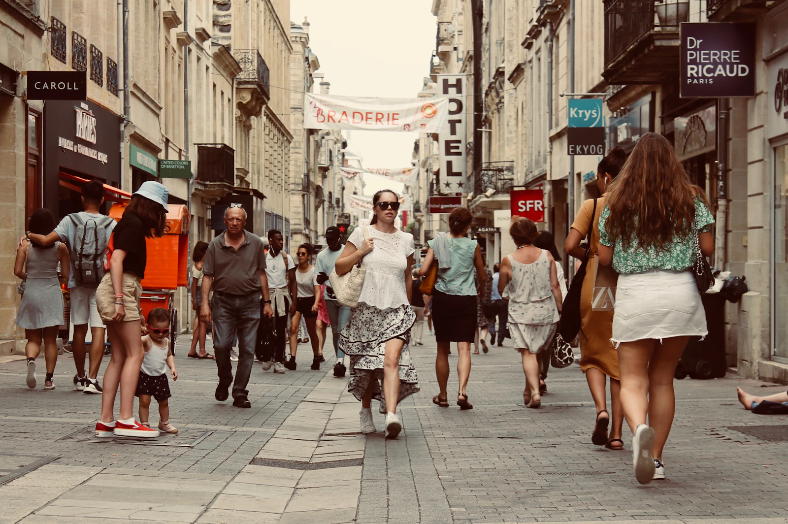 People walking briskly along a city street in daytime