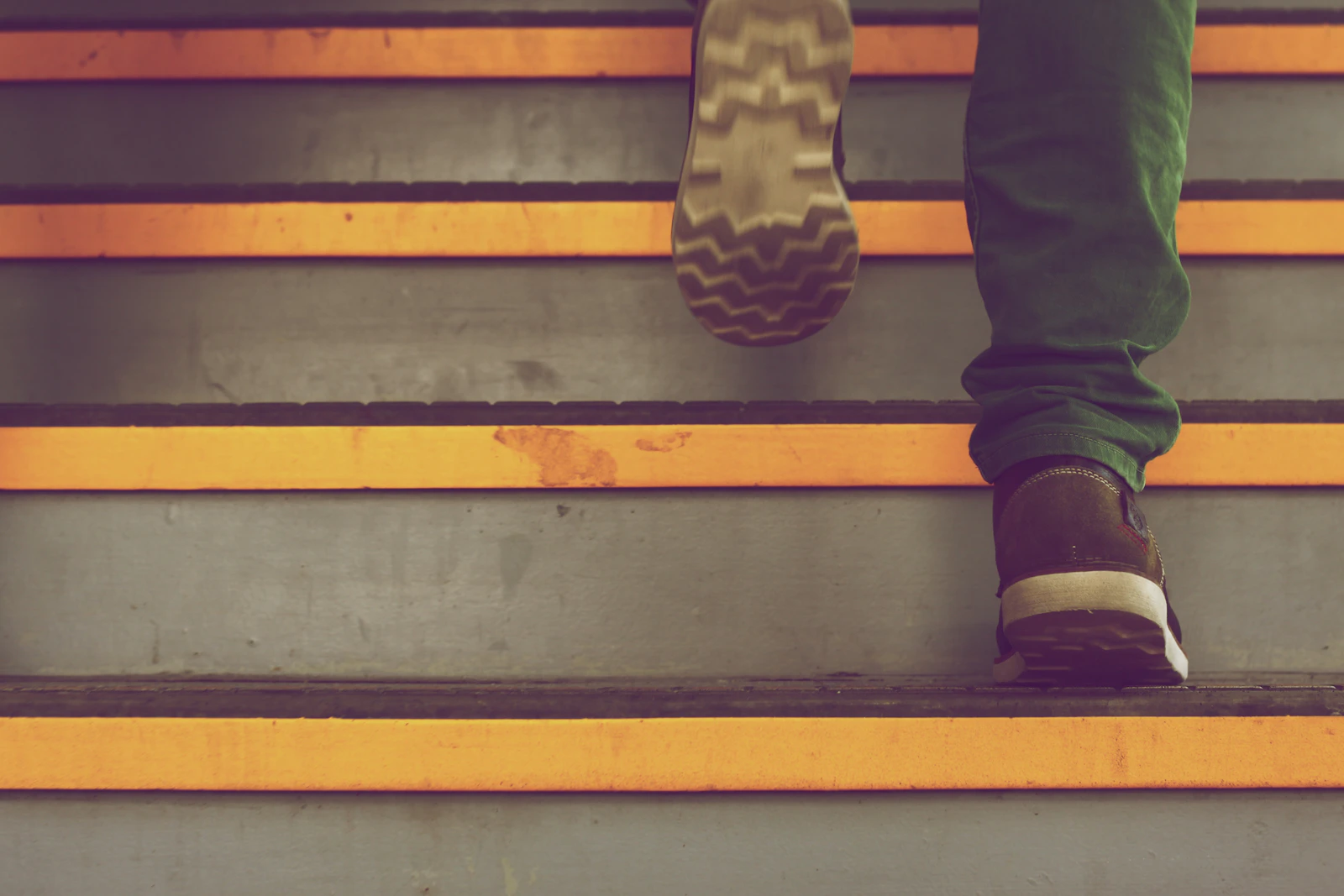 Person climbing a staircase at a dynamic pace