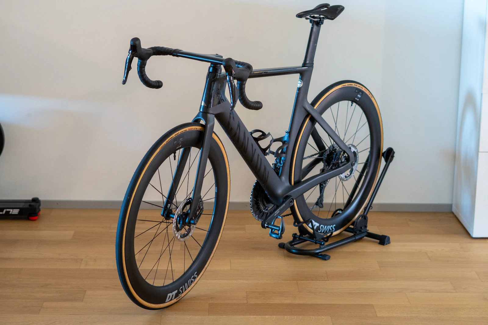 Cyclist on an indoor trainer wearing headphones during an endurance workout